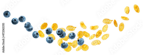 flying cornflakes with blueberries on a white background. diagonal cornflake isolate with berries