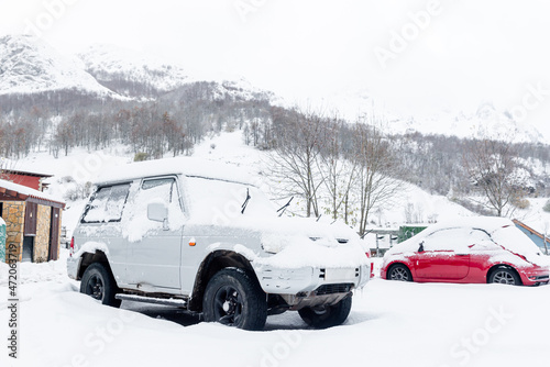 White 4x4 off-road car with all terrain wheels covered in snow. winter concept