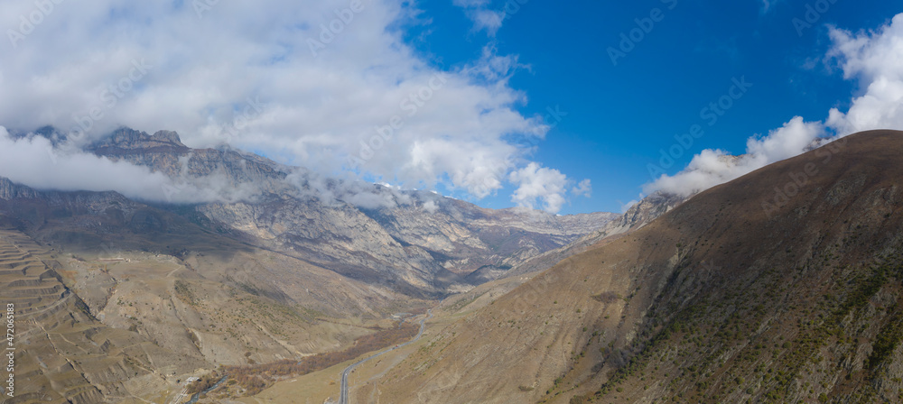 Scenic autumn mountain gorge landscape with snow peaks, Fiagdon, Northern Ossetia, Caucasus, Russia