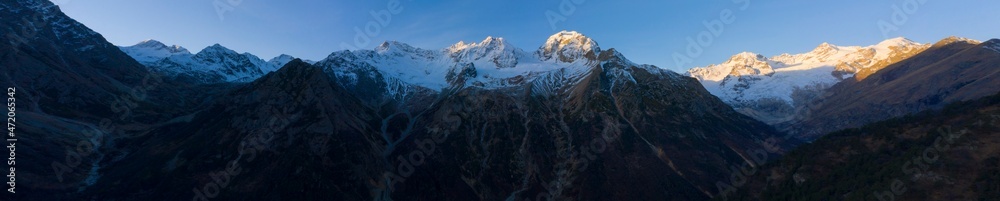 Scenic autumn mountain landscape with snow peaks, Tuymazinsky glacier, Digor Gorge, Northern Ossetia, Caucasus, Russia