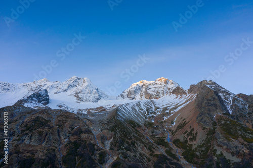 Sunrise scenic autumn mountain landscape with snow peaks, Tuymazinsky glacier, Digor Gorge, Northern Ossetia, Caucasus, Russia