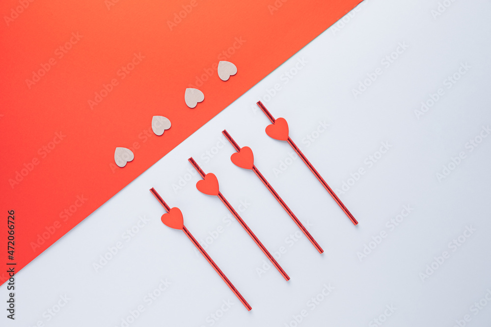 Love celebration drinking straws minimal layout on a geometric pastel background. Love celebration drinking straws minimal layout on a geometric pastel background.
