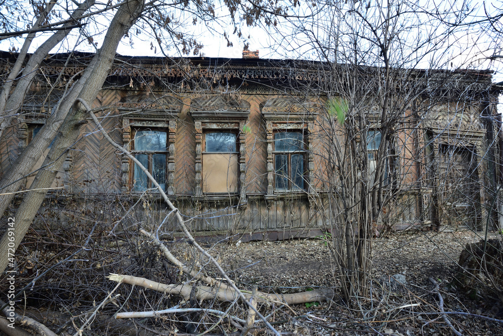 Orel city. Abandoned old wooden house overgrown with bushes.
