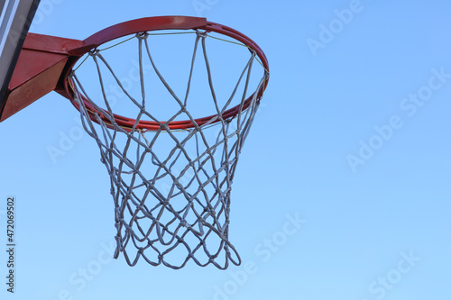 Basketball hoop with net outdoors, space for text © New Africa