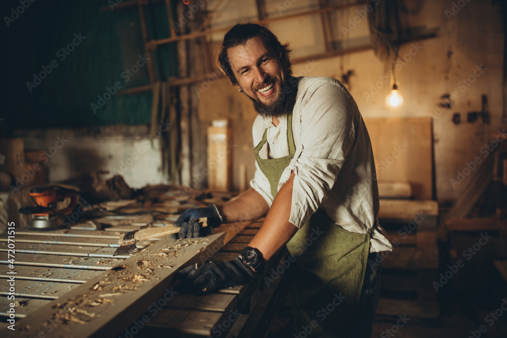 A male joiner works in the workshop. High quality photo A male joiner works in the workshop. High quality photo