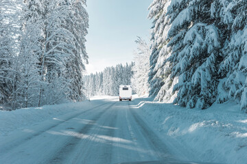 Camper auf einer verschneiten Straße in den Bergen