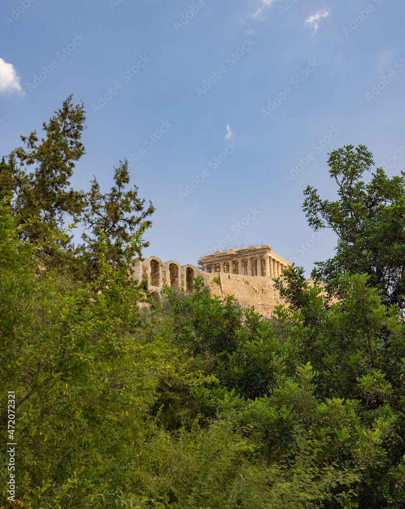 View of the Parthenon Temple at Acropolis hill, in Athen, Greece. The famous old Acropolis is a top landmark of Athens. Scenic view of remains of ancient Athens.