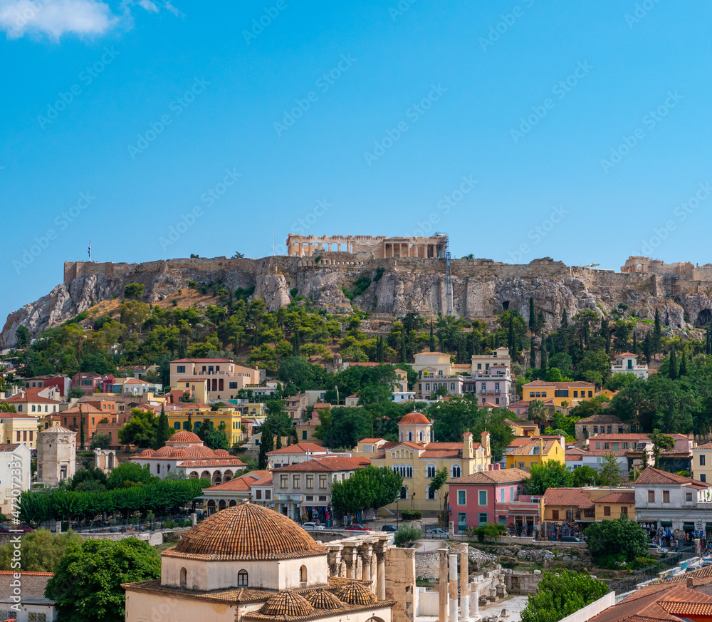 Aerial panoramic view of Monastiraki square and the ancient Parthenon on Acropolis hill in Athens, Greece.