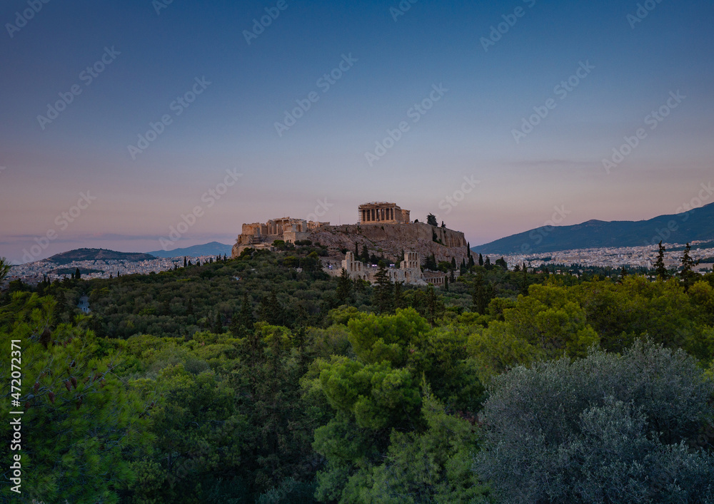 Evening view of the Parthenon Temple at Acropolis hill, in Athen, Greece. The famous old Acropolis is a top landmark of Athens. Scenic view of remains of ancient Athens.