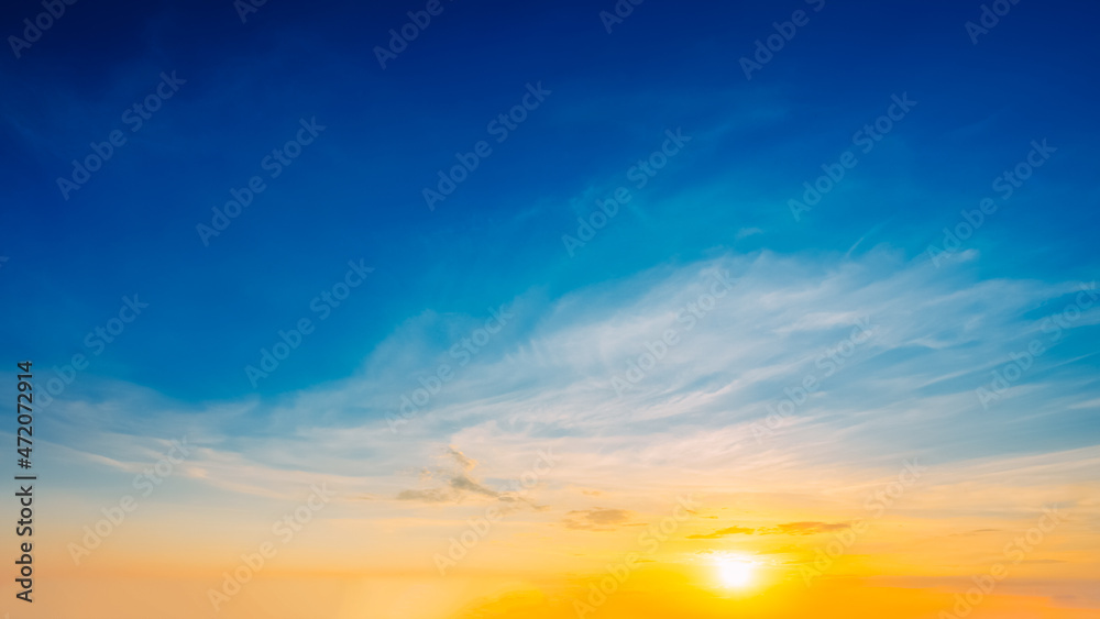 Beautiful Natural Sunset Sunrise. Panoramic Background. Blue, yellow and orange colors of natural sunrise.