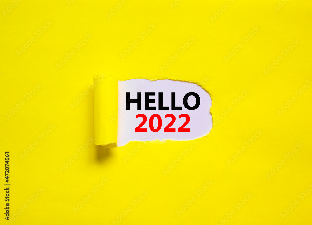 2022 hello new year symbol. Concept words Hello 2022 appearing behind torn yellow paper. Beautiful yellow background. Business, hello 2022 new year concept, copy space. 2022 hello new year symbol. Concept words Hello 2022 appearing behind torn yellow paper. Beautiful yellow background. Business, hello 2022 new year concept, copy space.