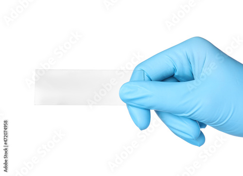 Scientist holding clean microscope slide on white background, closeup