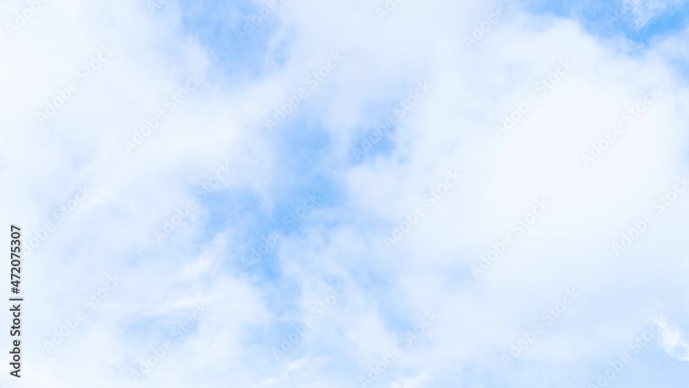 Light white clouds fly across a bright blue sky. Clear sky at sunny summer afternoon. Spring cloudscape background. Copy space at Phuket Thailand. Light white clouds fly across a bright blue sky. Clear sky at sunny summer afternoon. Spring cloudscape background. Copy space at Phuket Thailand.