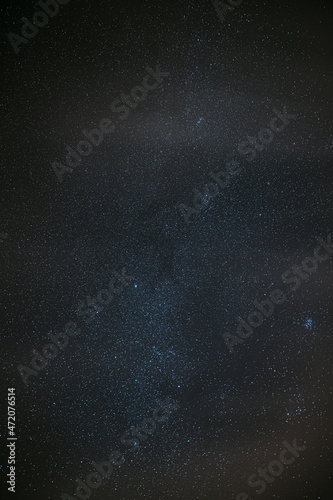 Milky Way Galaxy Glowing Through The Light Cloudiness Overcast. Real Night Sky Stars. Natural Starry Sky Dark Black Background Backdrop