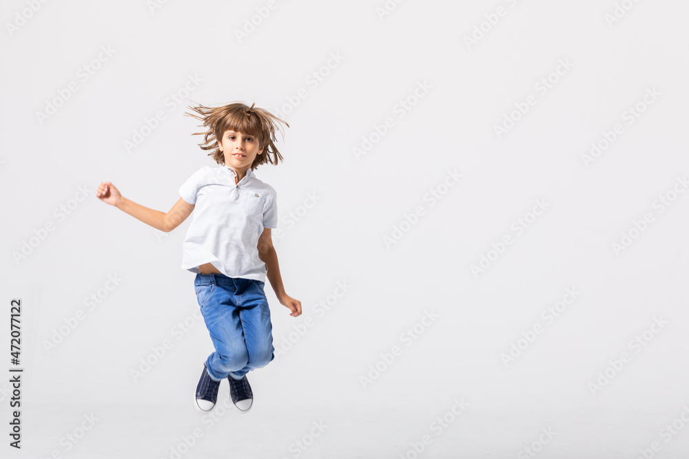 Cool teenage boy jumps in an empty room Cool teenage boy jumps in an empty room