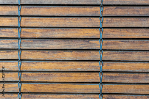 Close-up to the wooden slats of a blind.