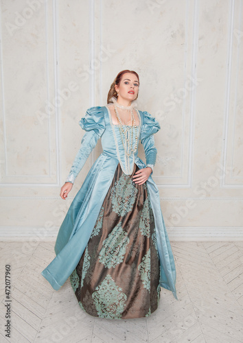 Beautiful young woman in medieval style dress move