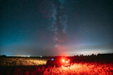 Night Starry Sky With Glowing Stars Above Countryside Road Landscape With SUV Car Vehicle Automobile. Milky Way Galaxy And Rural Field Meadow