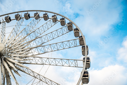 Big ferris wheel in the old town of Gdansk, blu sky background.