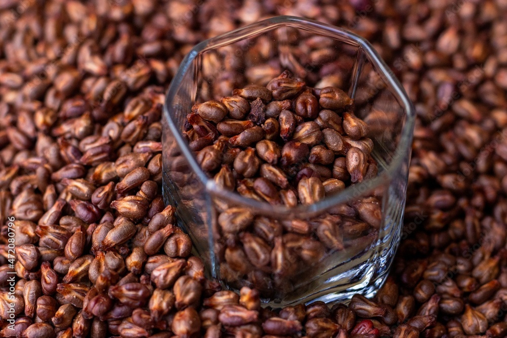 Dried grape seed seeds in a glass cup on the background of a placer
