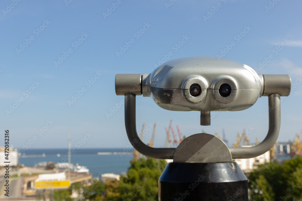 Public binoculars for exploring the port city on the observation deck in the city park