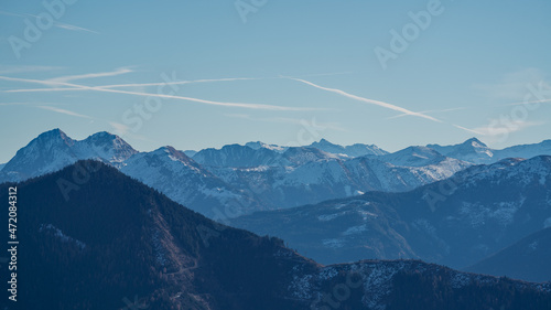 hiking on the mountains at a sunny autumn day with a beautiful view of the snow capped alps in austria
