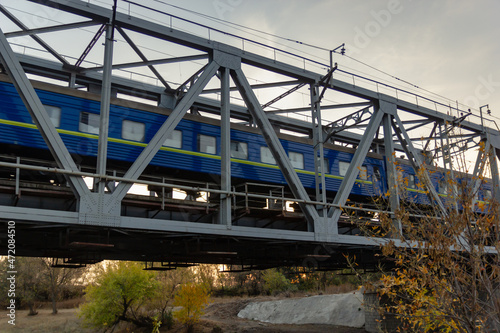 railroad and railway bridge and a passing passenger train