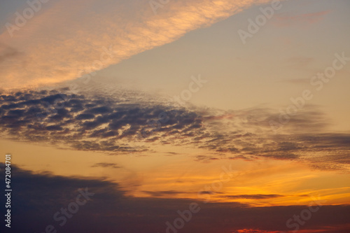 Colorful clouds in the setting sky as a background. © Arthur