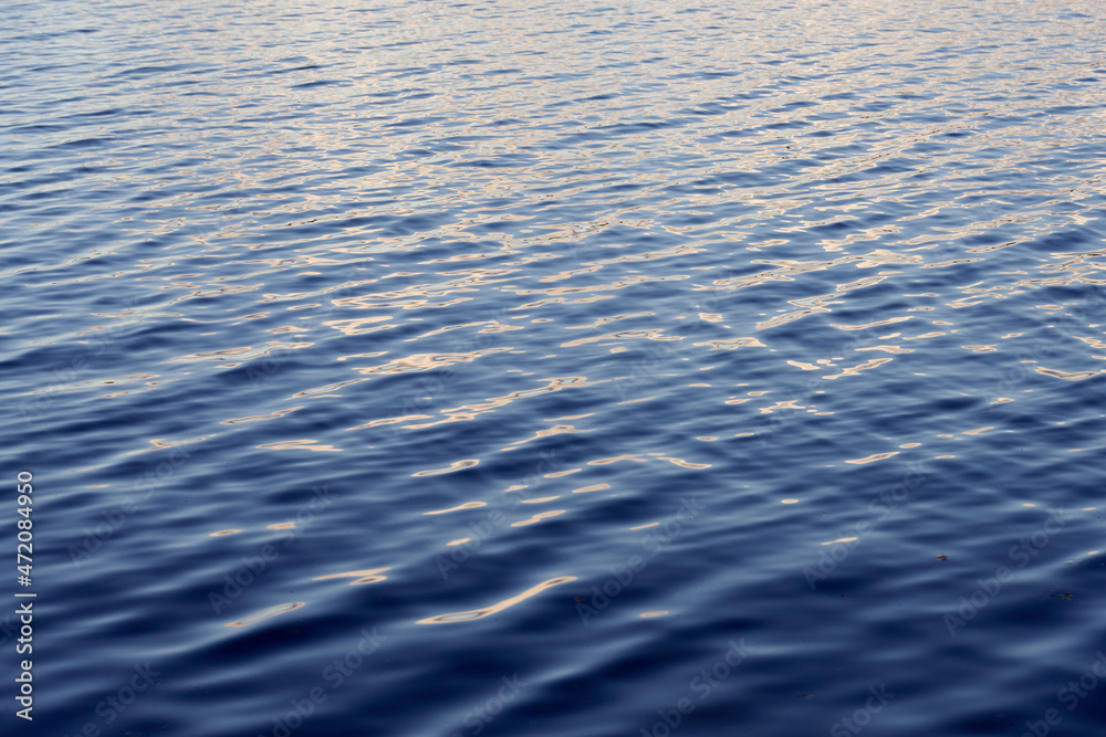 Light ripples of waves on the surface of the lake water. Light ripples of waves on the surface of the lake water.