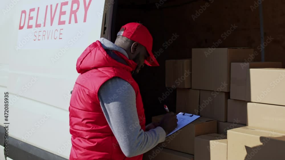 African american delivery man delivering parcel box to recipient