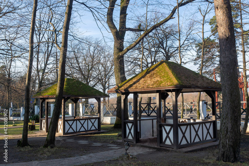 Several wooden pavilions in the fall outside the city.