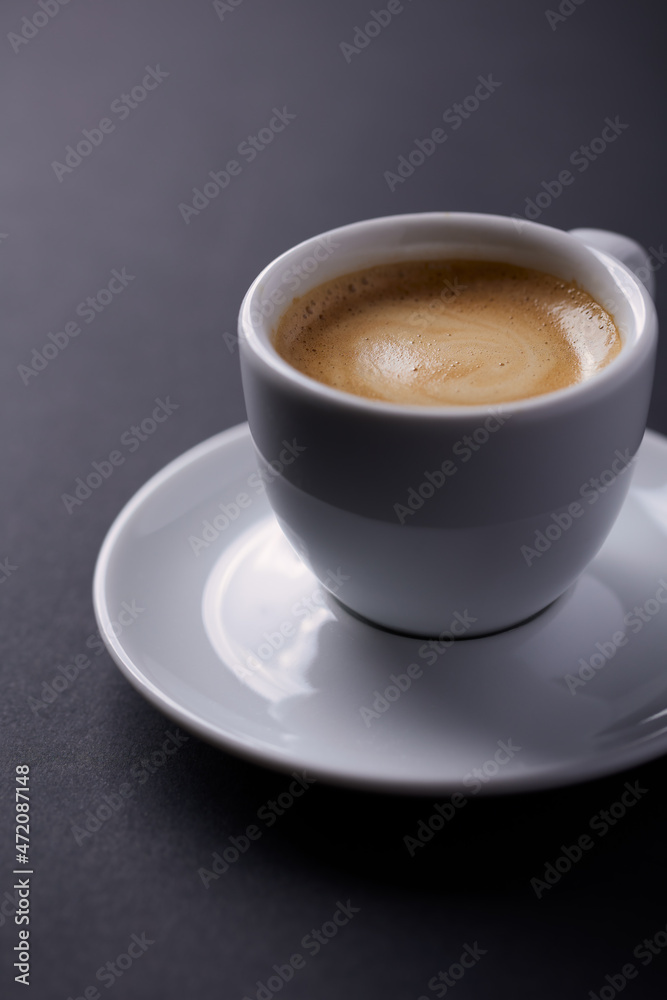 Cup of coffee on dark paper background. Close up. Cup of coffee on dark paper background. Close up.