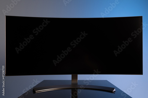 Photography professional widescreen curved gaming monitor close-up on gray-blue stylish back