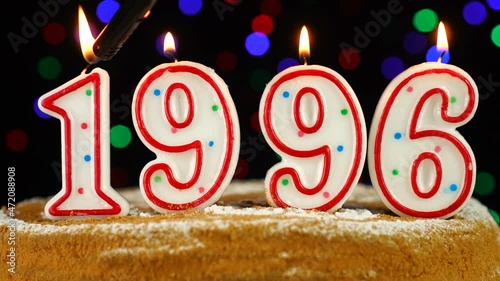 Birthday cake with white burning candles in the form of number 1996