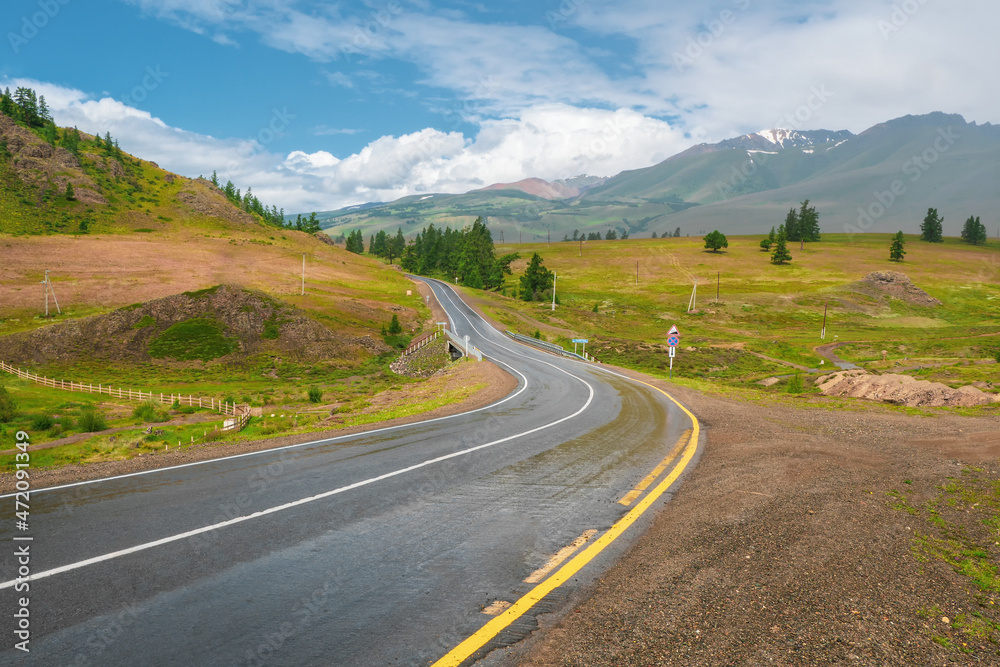 Turn on the asphalt mountain highway. Chuysky tract and a view of the North Chuysky Mountain range in the Altai, Siberia, Russia.