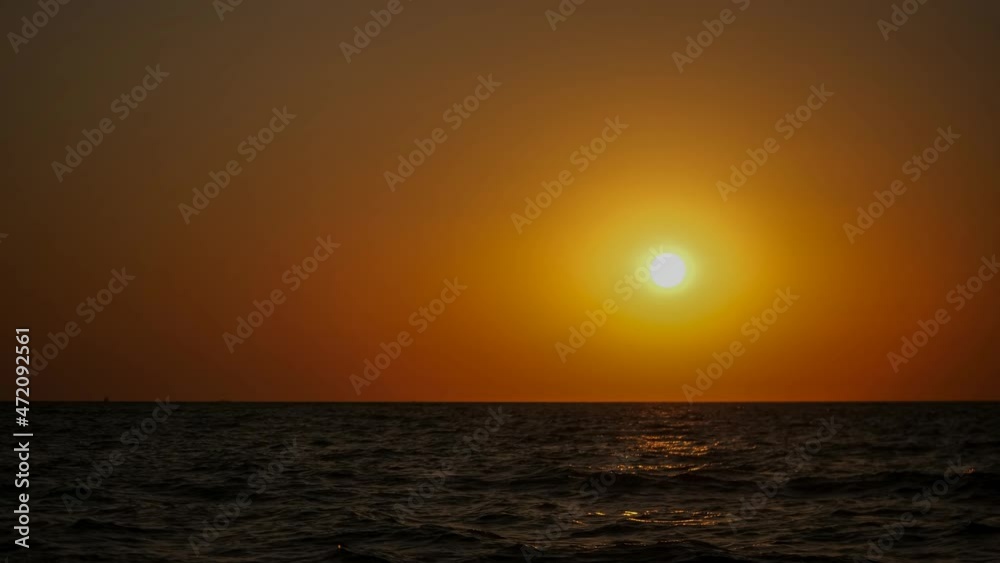 Timelapse. Sunset of the summer sun on the sea.