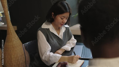 Attractive asian female interview male for a job in modern company 