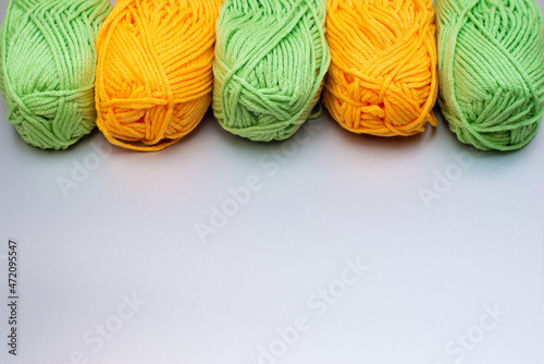 Free time needlework concept. Multicolored bright skeins of yarn on a gray background. Copy space. Background.