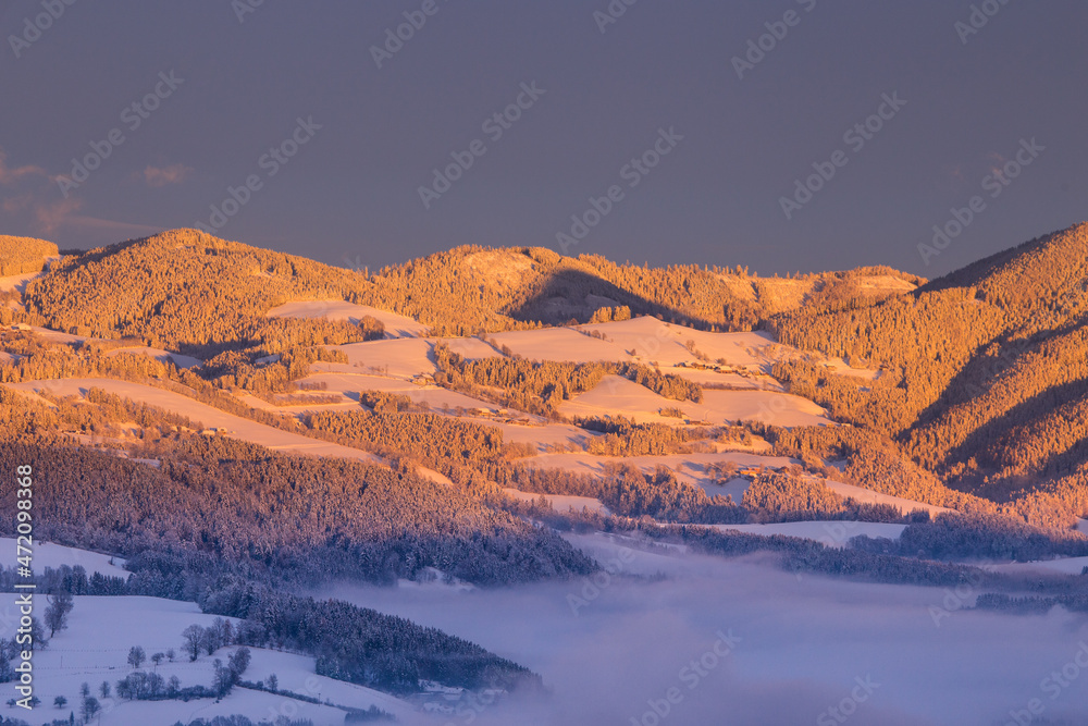 Beautiful winter landscape with hills and mountains during sunset