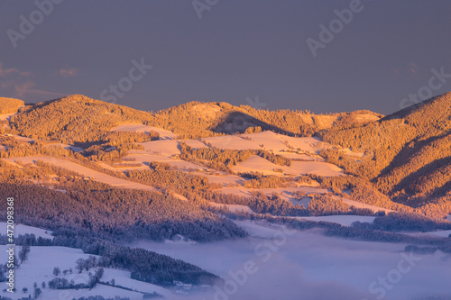 Beautiful winter landscape with hills and mountains during sunset © Photofex