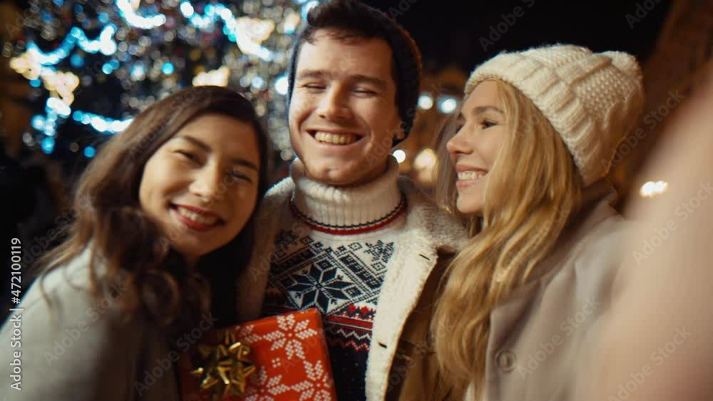 Point of view shot of man vlogger recording video for his blog about party with friends on night, people are looking at camera, dancing and talking.