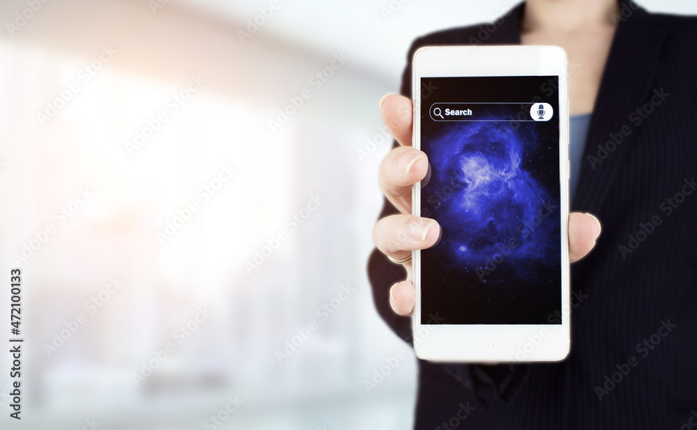 Hand hold white smartphone with digital hologram sign on light blurred background. Searching Internet Data. Web Browsing Concept. Searching information data on internet networking concept.