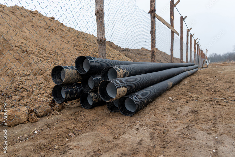 black pipes for sewage at the construction site