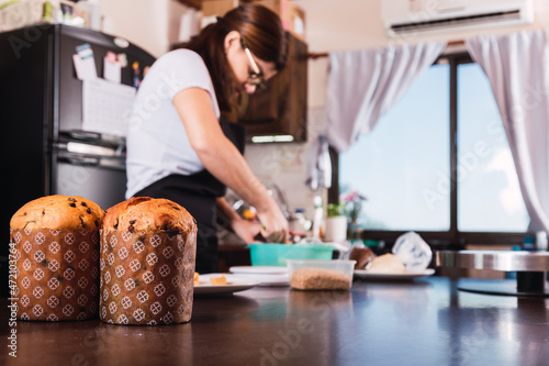 Traditional Christmas Panettone with dried fruits. Cook preparing Christmas bread.