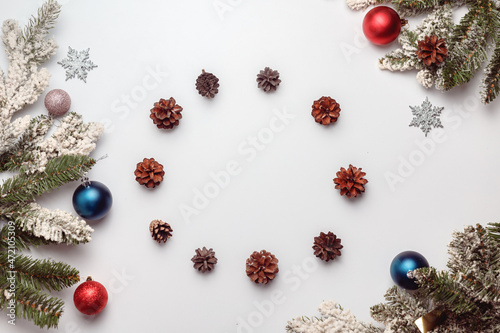 Christmas or New Year background, plain composition made of decorations and fir branches, flat lay, blank space for text