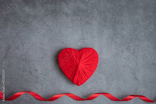 Heart for Valentine s Day made of red wool threads on a dark background. Space for text. Concept holidays, love. photo