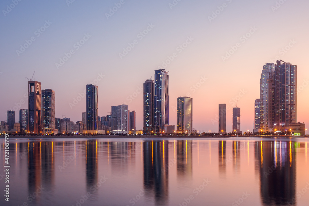 Fototapeta premium The tallest towers in the Emirates and their reflection on the lakes at night, Dubai, Sharjah