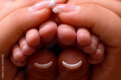 newborn's legs in mom's hands, french manicure, manicure