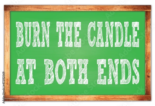 BURN THE CANDLE AT BOTH ENDS words on green wooden frame school blackboard photo