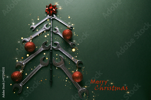 Christmas tree made of various tools on a green background. Happy christmas and happy new year. Merry Christmas lettering